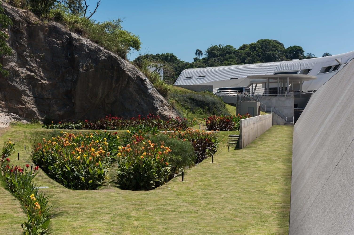 Central courtyard at Kaia Bio Cosmetics Innovation Campus with trees, seating and shaded walkways.